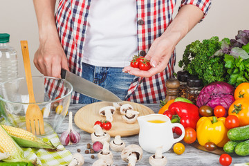 Woman cooks at the kitchen, body part, blurred background