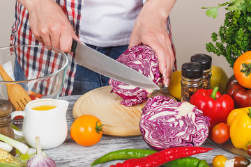 Woman cooks at the kitchen, body part