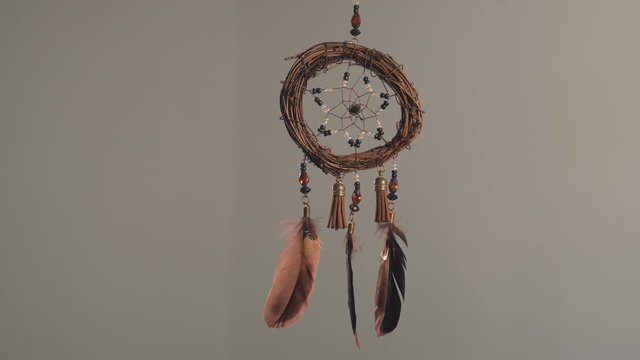 view of a dream catcher hanging in a wall 