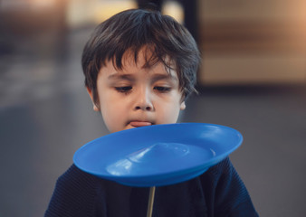 Kid learning how to play spinning plate, Preschool boy balancing bolw on wooden pole, Children...