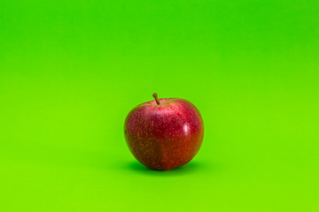 Red apple on a green background