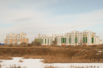 Modern buildings with office buildings on the background of a lake full of reeds