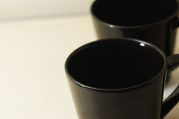 black porcelain cup on a bright wooden table