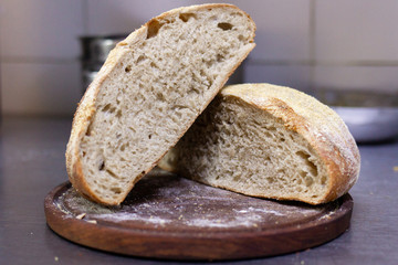 homemade bread cut in half served on a wooden board