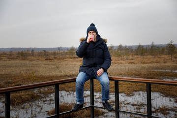 Fototapeta na wymiar portrait of a man in nature with a thermos