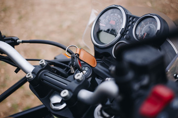 Fototapeta na wymiar Close up behind shoulder shot of motorcycle handlebar. Speedometer and powermeter computers on handlebar. Touring or adventure off road motorcycle