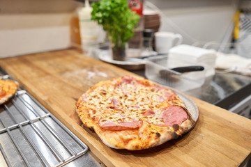 Neapolitan Iberian ham artisan pizza. pizza with bacon ham and sausage on wooden table. kitchen