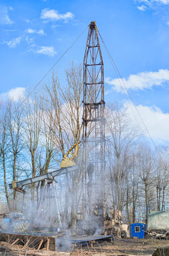 Workover rig working on a previously drilled well trying to restore production through repair.
