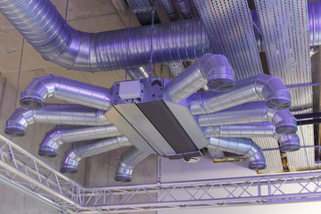 Industrial ventilation system ducts and pipes and electrical communications under ceiling