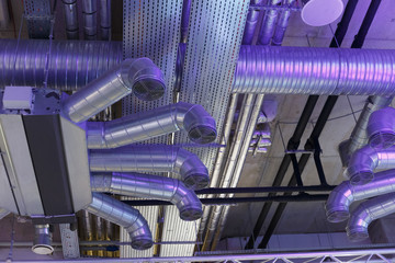 Industrial ventilation system ducts and pipes and electrical communications under ceiling
