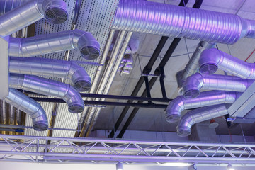 Industrial ventilation system ducts and pipes and electrical communications under ceiling