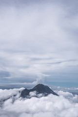 Mountain surrounded by thick clouds