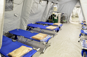 Empty hospital field tent for the first AID, a mobile medical unit of red cross for patient with...