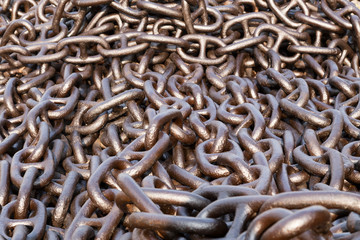 Large rusty metal iron chain piled up in a heap