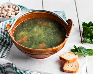 Mushroom, vegetable. vegetarian soup with croutons in a plate on a white wooden table. Healthly...