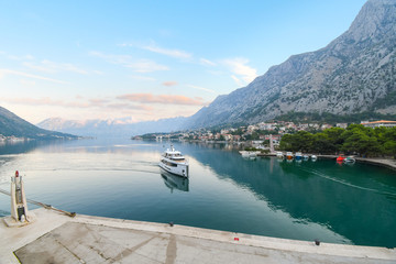 A luxury yacht pulls into the port at the Bay of Kotor, or Boka, early  morning in Kotor Montenegro.