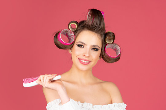 Beauty woman with hair curlers. Portrait of beautiful woman with hair curlers. Fashion of beautiful brunette woman with curler in the hair. Beauty hairstyle girl.