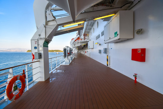 The empty outer deck of a cruise ship with no identifiable features cruising the Aegean Sea on a summer day.