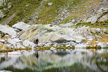 MOUNTAINS AND CLOUDS REFLECTED ON LAKE
