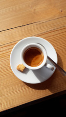 A cup of Italian coffee on the table with heart-shaped biscuit. View from top.