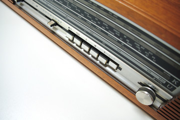 Old vintage radio in wooden case, retro style. Close up.