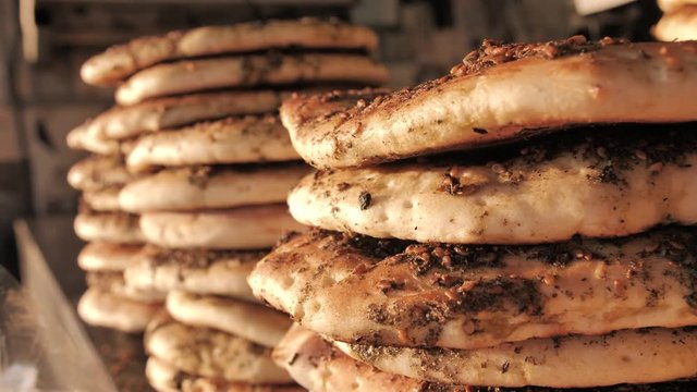 Freashly baked arab flatbreads at Mahane Yehuda Market in Jerusalem. Mediterranean Pita Bread with zaatar. Manakish or Za'atar bread. A popular Levantine food (Lebanese cuisine. Cuisine of Israel