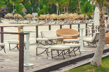 Outdoor terrace with Empty wooden table and chair with Sea view of Indain ocean, Maldives background. Chairs, table and sofa at the Terrace with panorama view of sea.