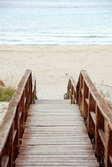 Wooden stairs down to sand beach
