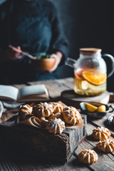 Woman cooks in a vintage kitchen on wooden tablet. Healthy drink, Eco, vegan.
