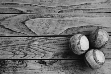 Rustic baseball background with used balls on wood texture.