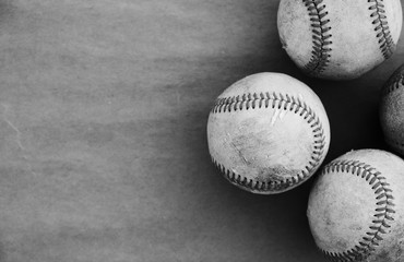 Black and white baseballs on old texture background.