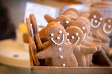 Gingerbread men arranged in a box on a market stall