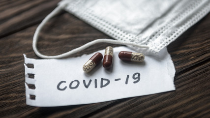 Surgical mask and pill capsules for treatment of COVID-19 coronavirus. Novel corona virus pandemic...