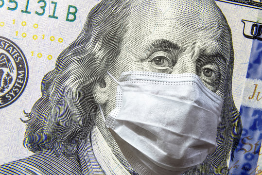 COVID-19 coronavirus and economy downturn, dollar money bill with face mask. COVID affects global stock market.