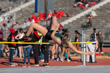 Young girl competing in the High Jump at a track meet