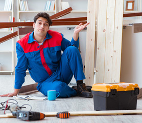 Young carpenter with notebook writing planning at construction r