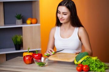 Young beautiful girl prepares a useful diet salad