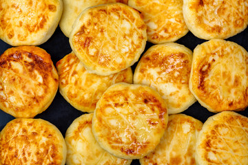 Fried round cheesecakes made from cottage cheese in butter. Texture