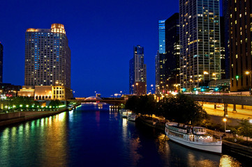 Nighttime reflections of the Chicago city skyline in the Chicago River.