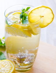 Glasss of mojito with lemon and drinking straw