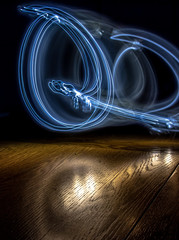 alphabet from a light painted shapes  on a wood table 