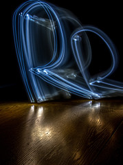 alphabet from a light painted shapes  on a wood table 