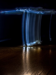 alphabet from a light painted shapes  on a wood table 