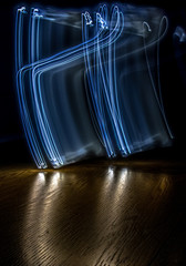 alphabet from a light painted shapes  on a wood table 