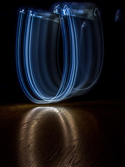 alphabet from a light painted shapes  on a wood table 