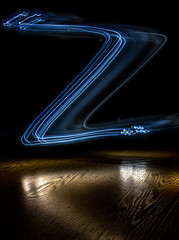 alphabet from a light painted shapes  on a wood table 