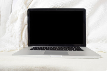 Laptop Relaxing on White Blanket with Clipping Path