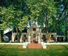 Fototapeta na wymiar A beautifully maintained cape dutch building surrounded by big Plane trees 