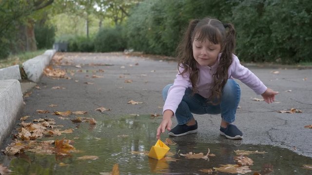 Toy boat in puddle.