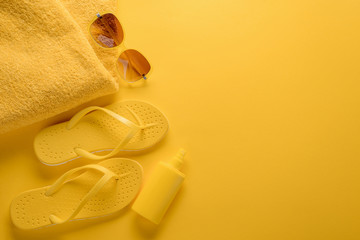 Towel, sunglasses, flip-flops and sunscreen